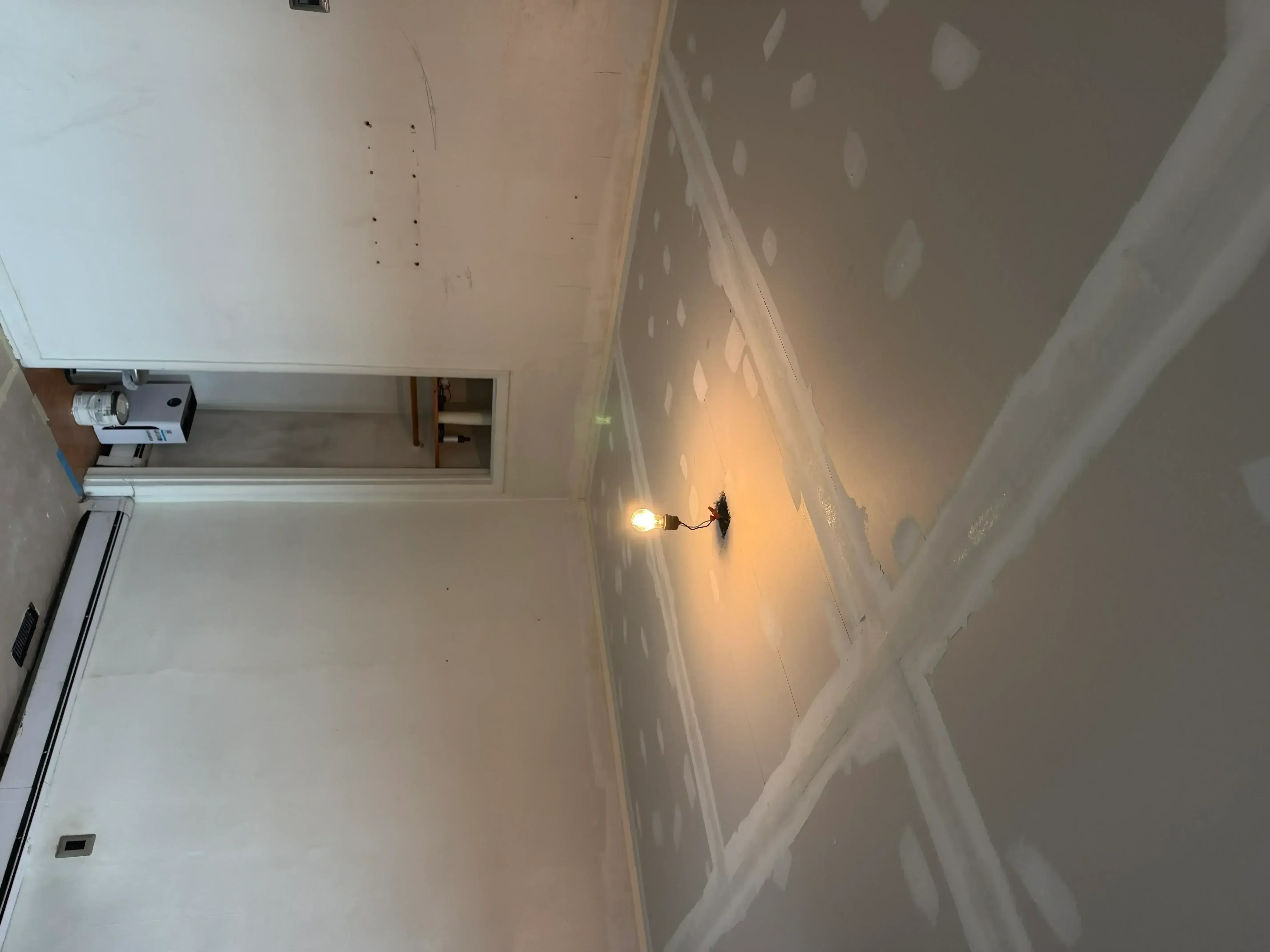 Drywall taping and mudding on walls and ceiling with recessed lighting installation