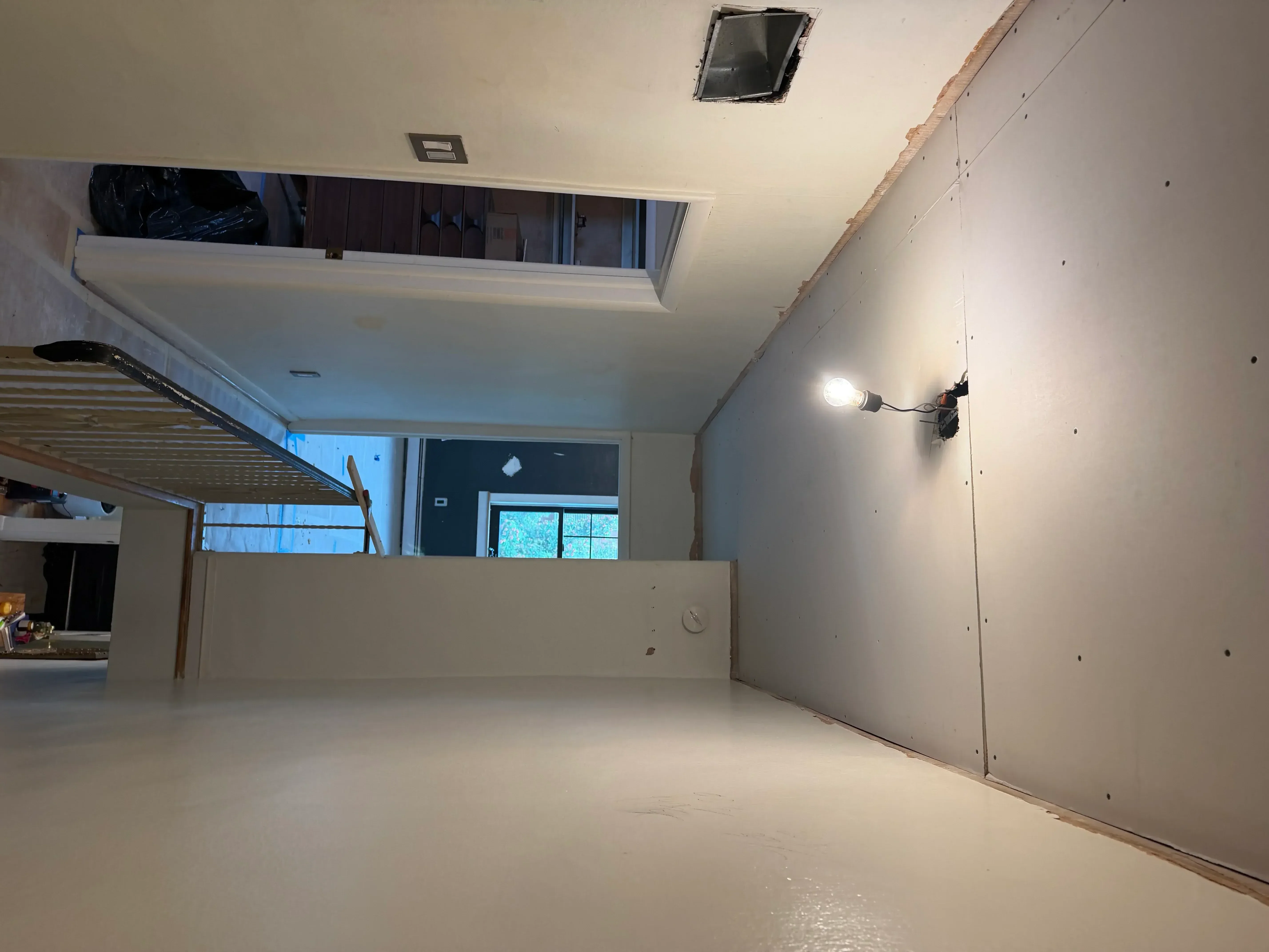 Finished drywall installation with taped seams, mudded walls, and primed ceiling in residential interior