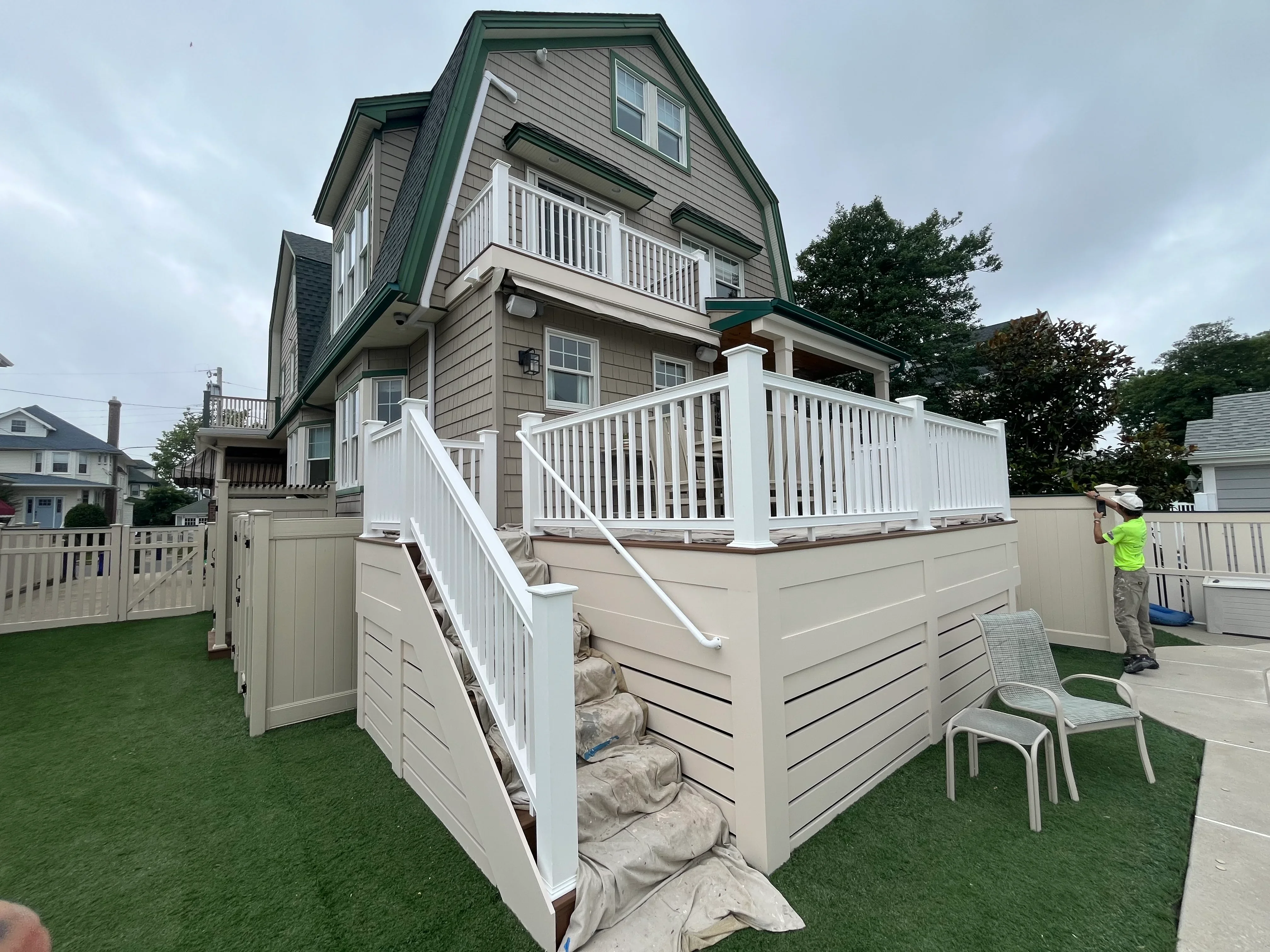White painted deck railings, fascia, and trim on elevated residential deck structure