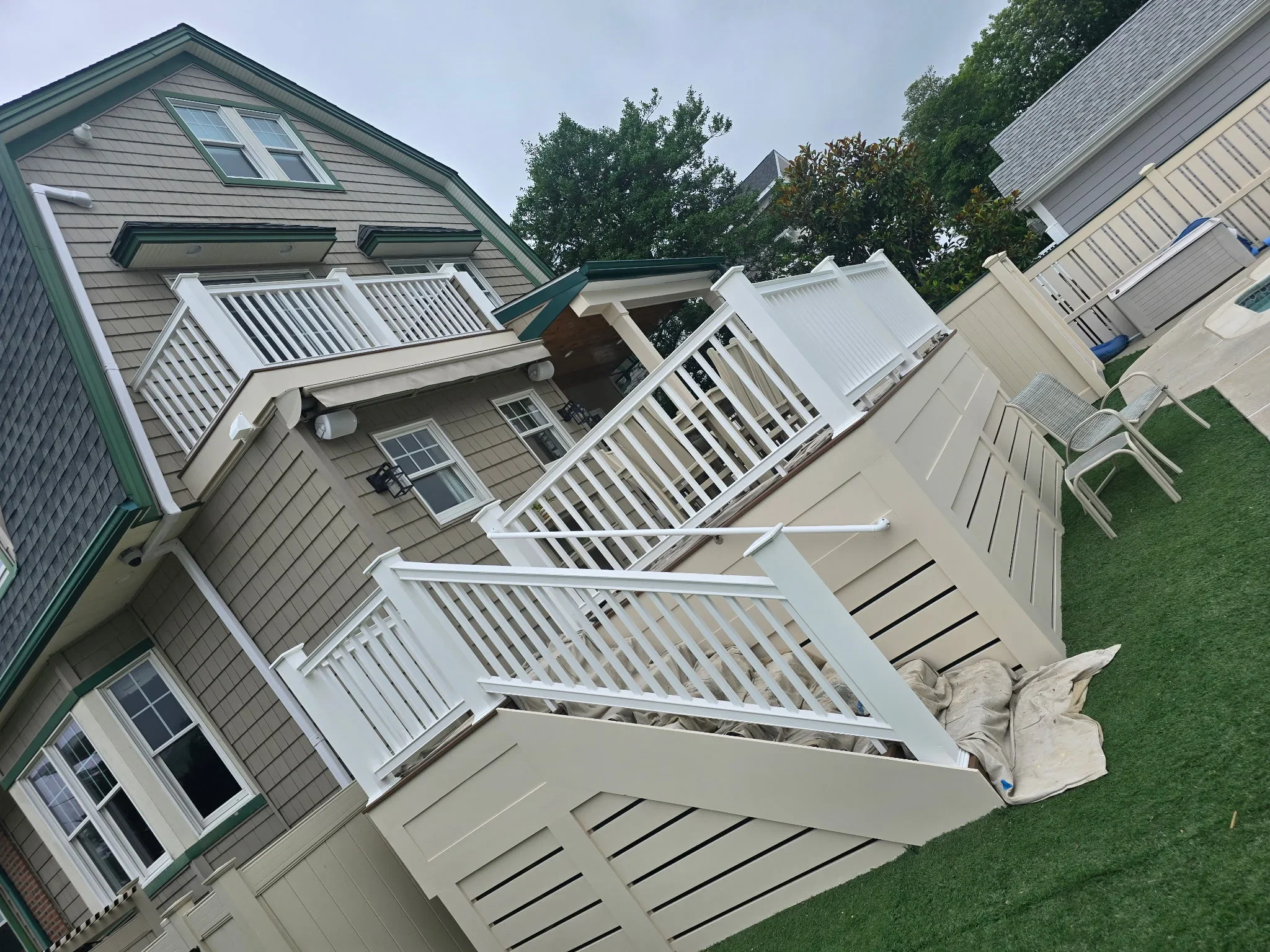White painted multi-level deck with railings and trim on residential home exterior