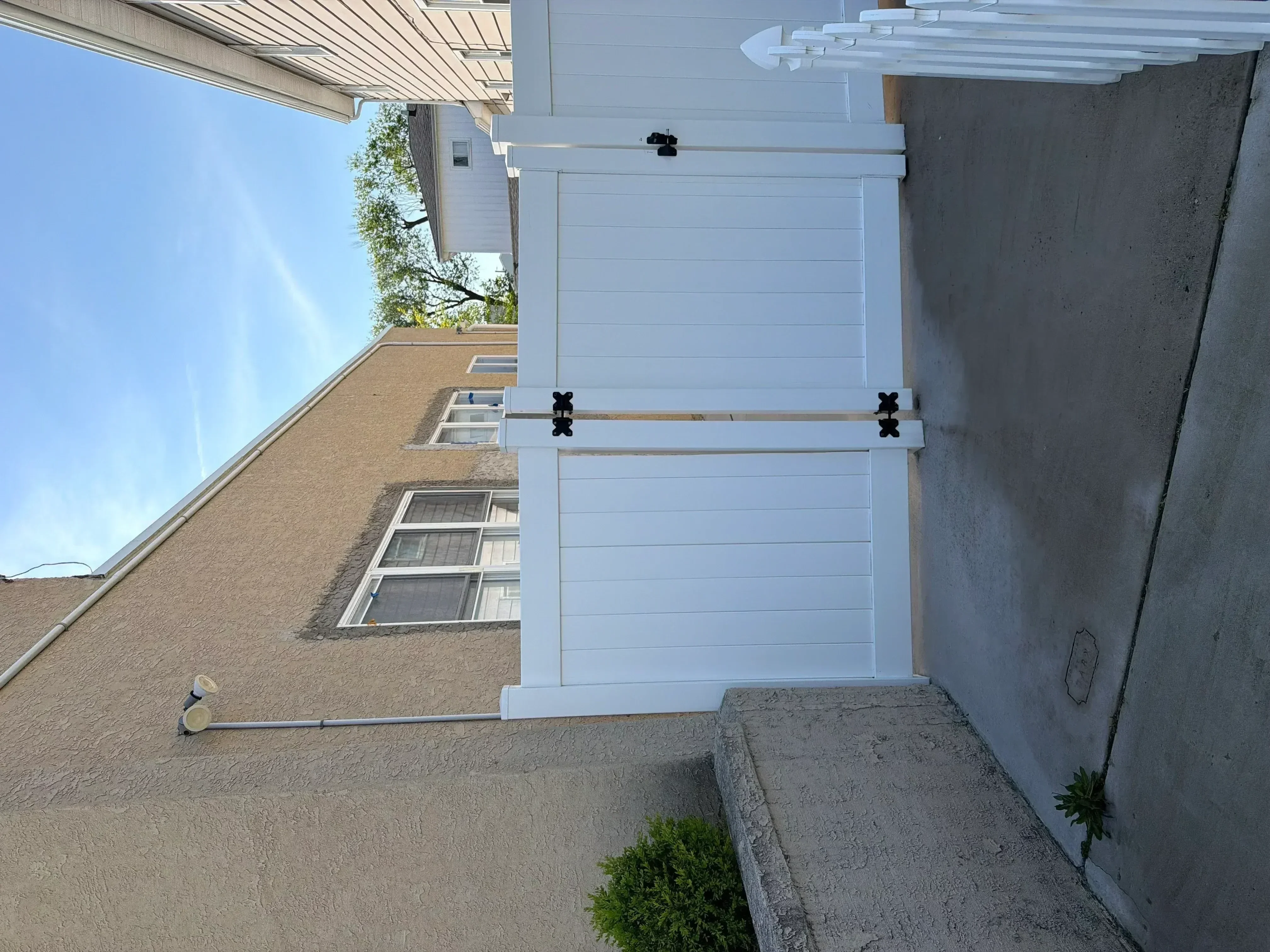 White painted exterior door with horizontal panels and black hardware on residential entry