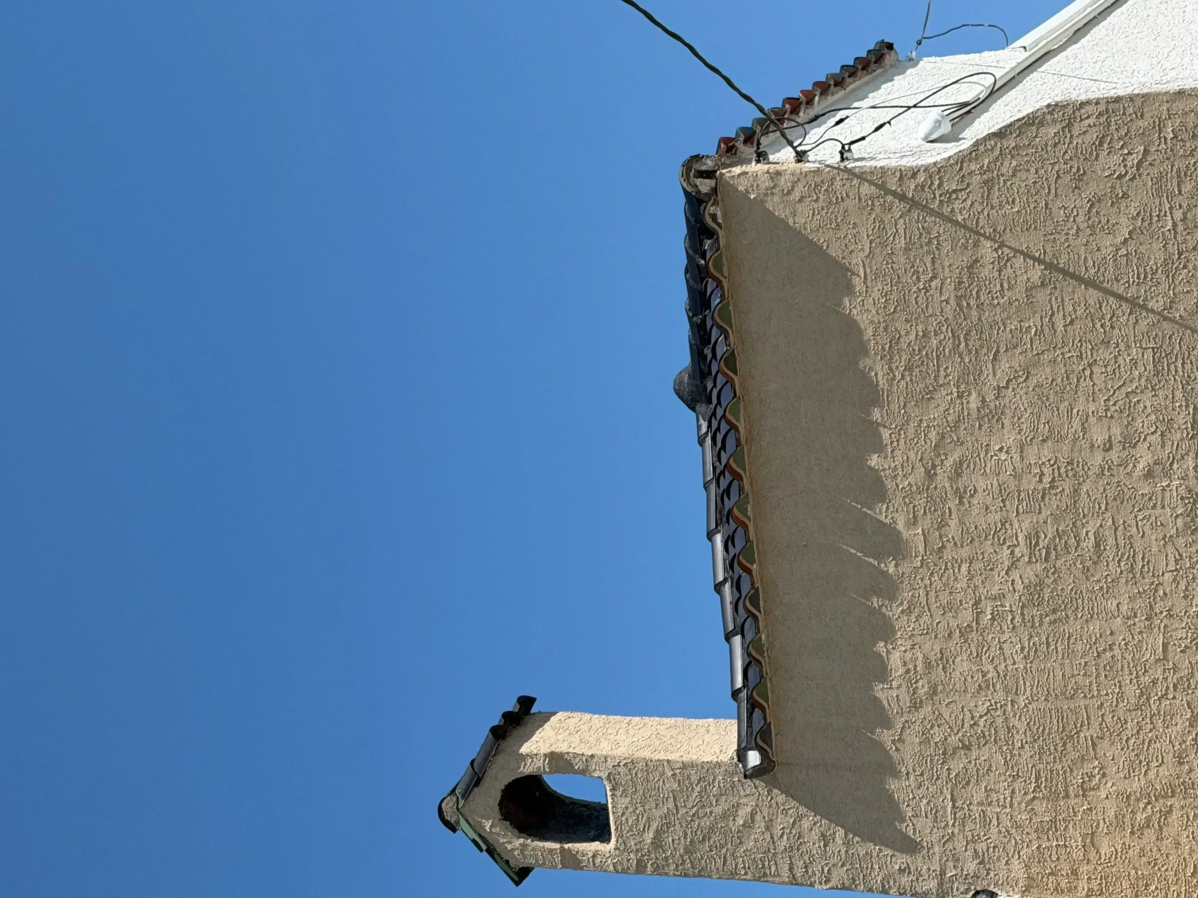 Textured stucco exterior wall painted with clean edges and professional finish