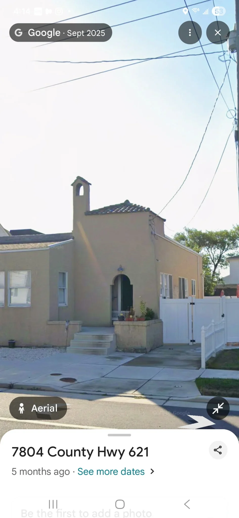Tan stucco home exterior with painted walls, chimney, and arched entryway