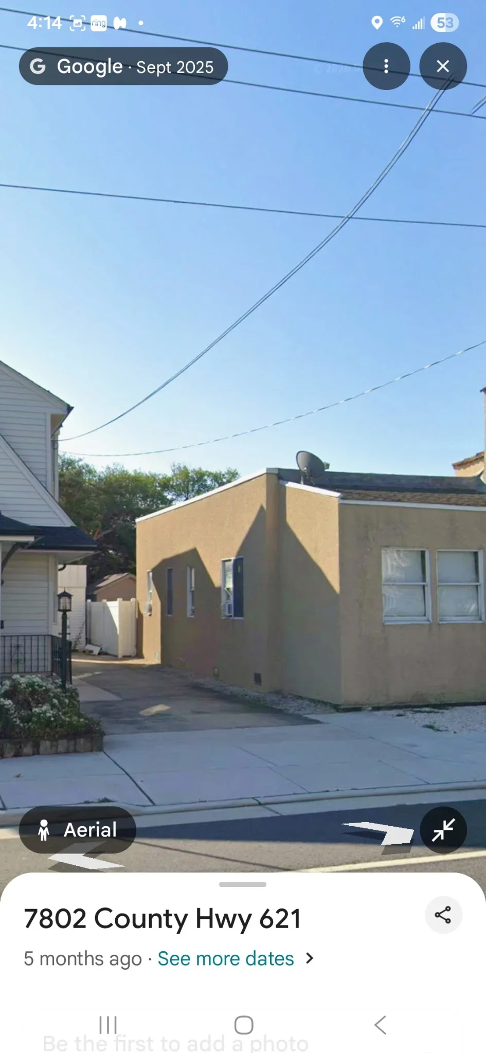 Golden-tan painted stucco exterior on residential addition with windows and trim
