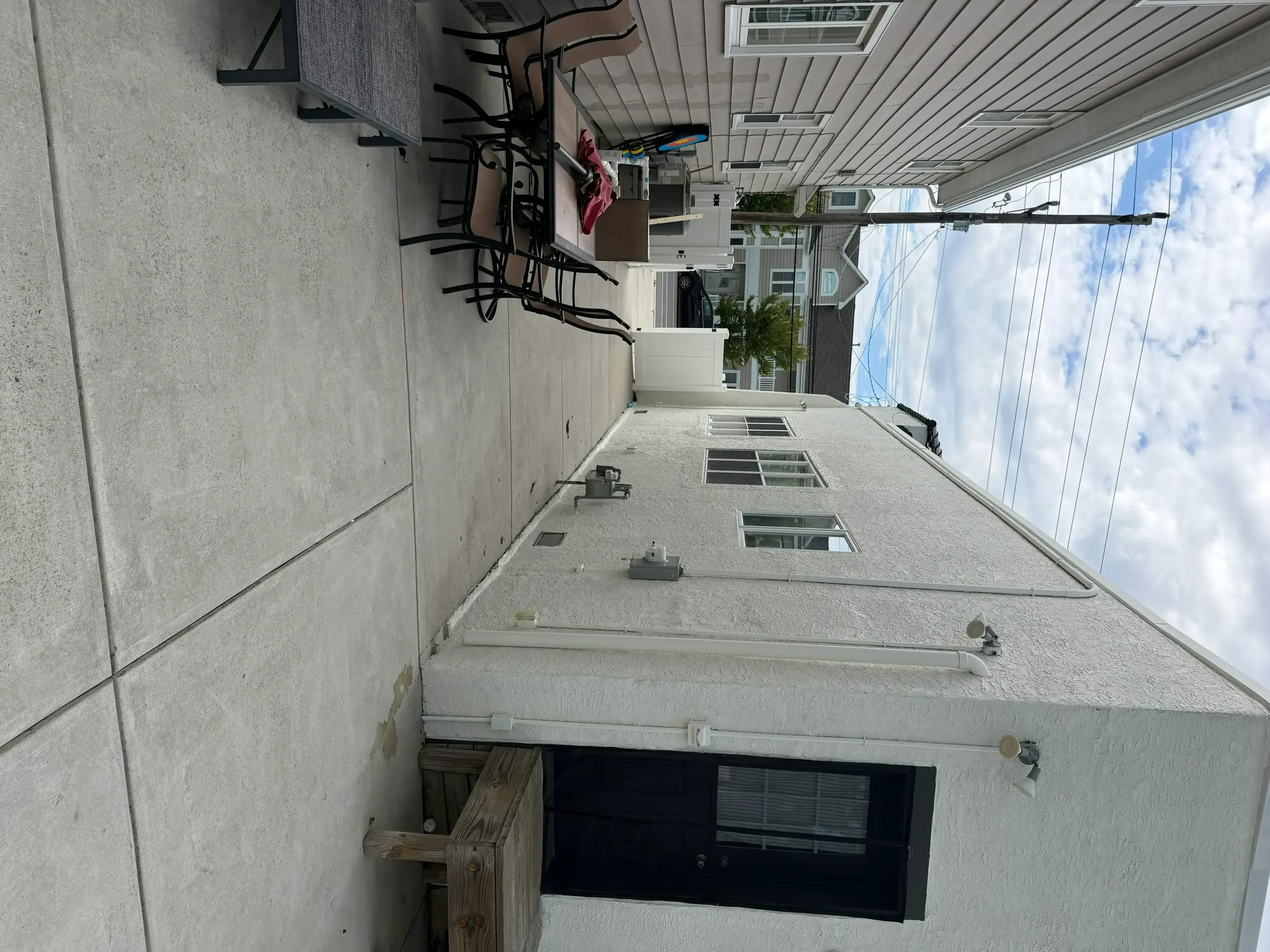 Exterior stucco walls and soffit painted on residential home with textured finish